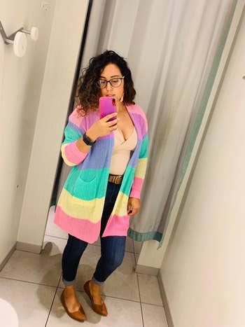 reviewer wearing the rainbow cardigan