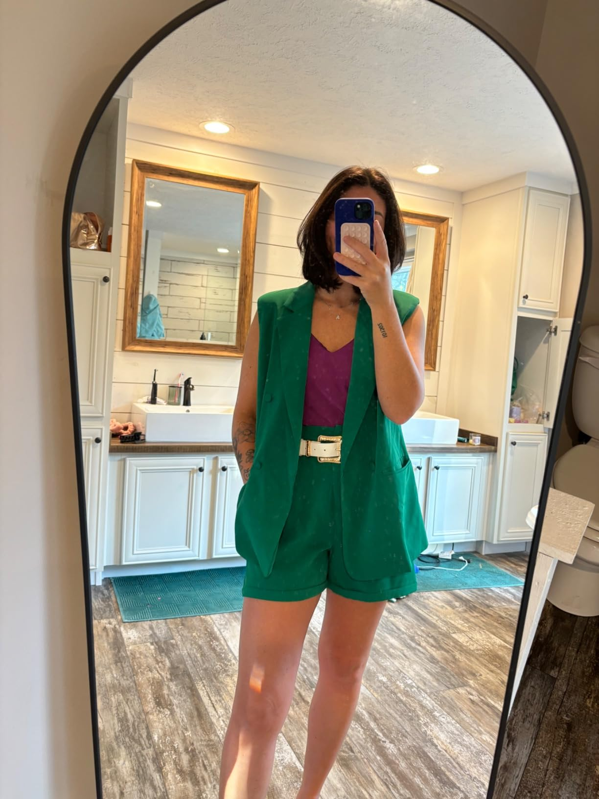 reviewer taking reflector  selfie and wearing two-piece shorts and vest acceptable   successful  green