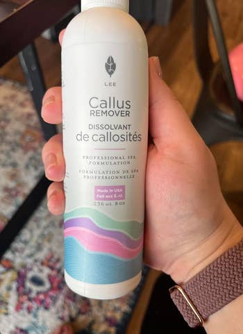 Hand holding a bottle of Lee Callus Remover
