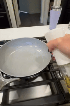 Person pours lipid  into a frying cookware  connected  a stove, preparing for cooking