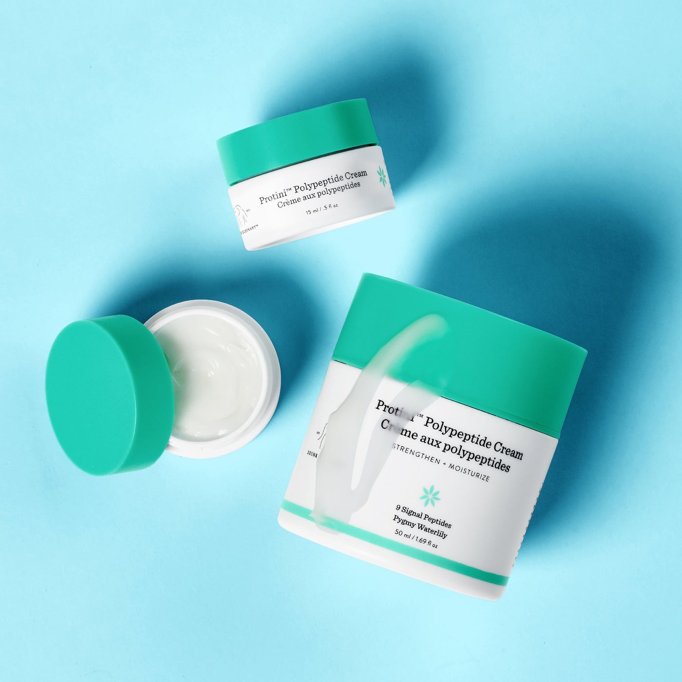 green and white containers of the Protini Polypeptide Cream
