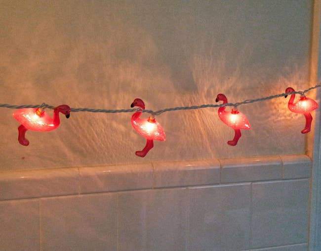 Reviewer image of pink flamingo string lights strung along a white wall