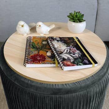 Two notebooks connected  a circular  array  ottoman 