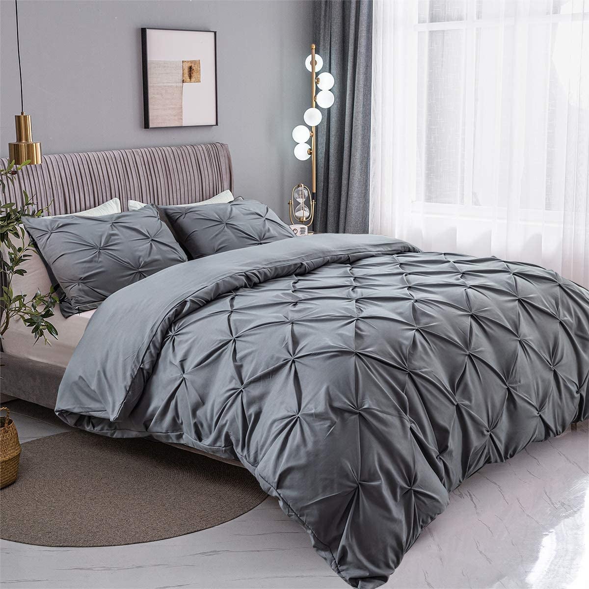 a dark gray pinch-pleated duvet set on a bed