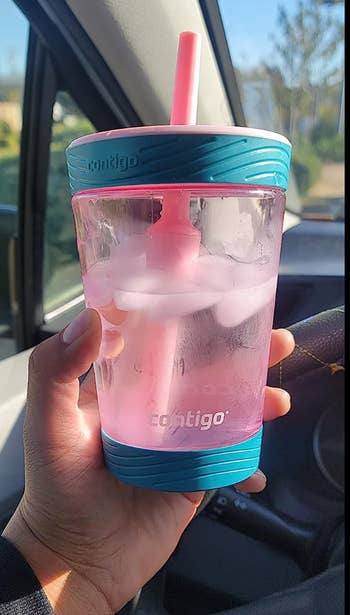 reviewer holding pink and blue cup