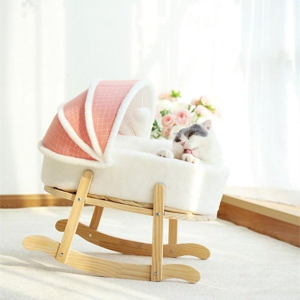 kitty in rocking chair bed with pink hood
