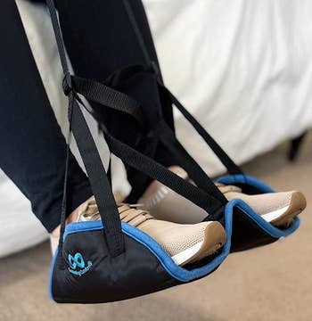 reviewer demonstrating their feet resting on the hammock