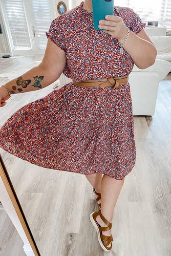 reviewer wearing the red floral print dress