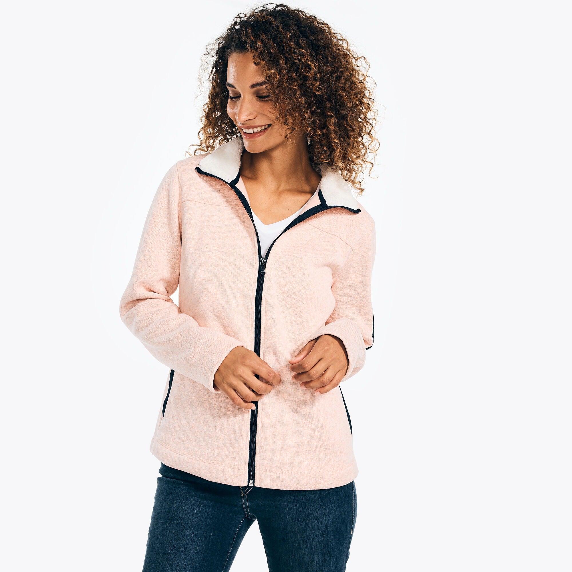 model wearing pink jacket with black trim and white fleece lining on the mock neck