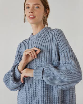 model wearing the sweater in blue