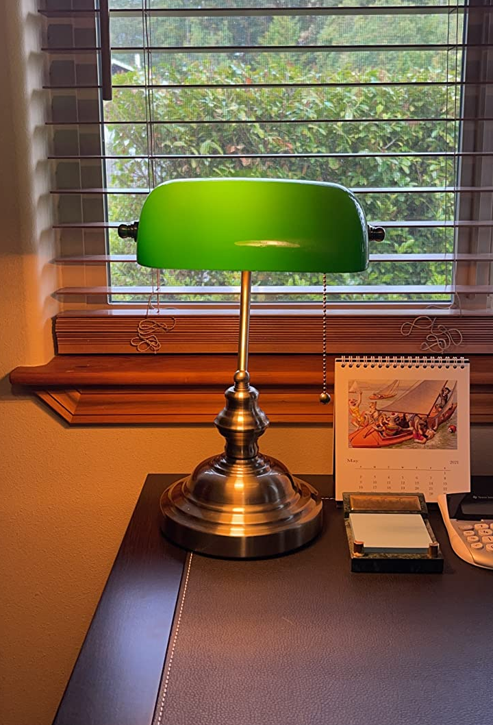 reviewer photo of a green bankers lamp lip on a desk