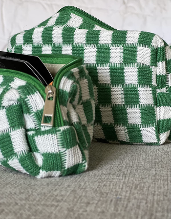 reviewer's two different sized zippered white and green checkered bags 
