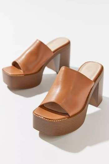 a pair of brown leather platform sandals