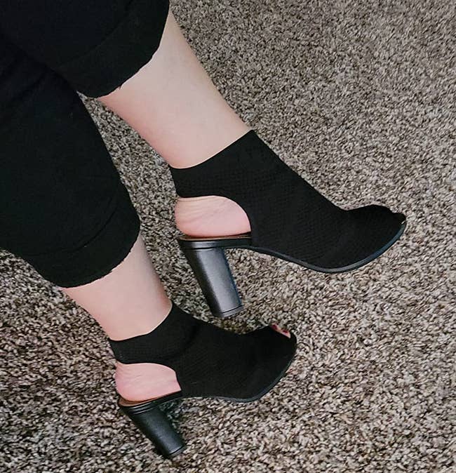 reviewer wearing the black perforated bootie