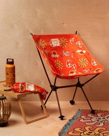 orange camping chair with peace signs and sun graphics