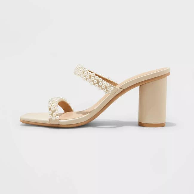 Pearl-embellished heeled sandal against a white background, ideal for elegant outfits