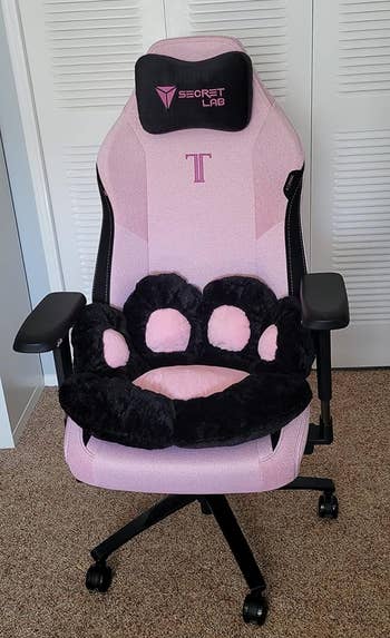 the small black cushion on a pink office chair