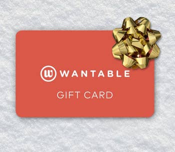 Wantable acquisition paper with a golden bow connected a textured background