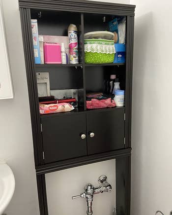 a reviewer photo of the storage cabinet in brown 