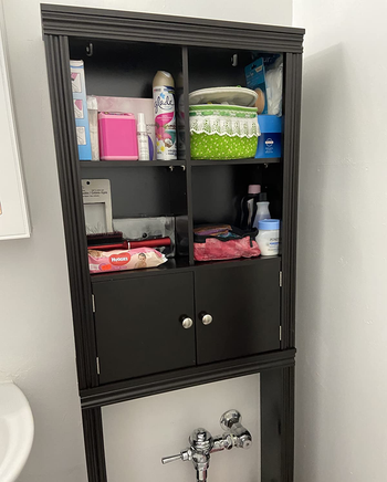 a reviewer photo of the storage cabinet in brown 