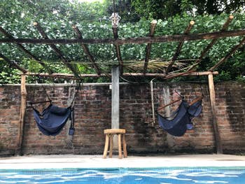 Faux vines placed on simple wood frame to make pool awning 