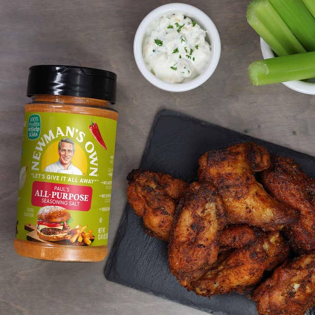 Chicken wings seasoned with Newman's Own All-Purpose Salt connected a slate plate, alongside a tiny vessel of dip and celery sticks for a buying article