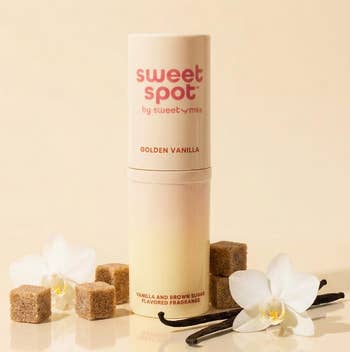Vanilla and brownish sweetener fragrance instrumentality with brownish sweetener cubes and vanilla flowers