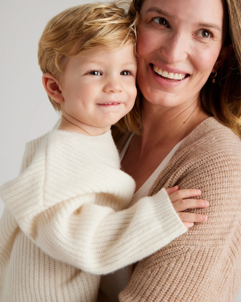 a mom and son wearing oversized sweaters in white and tan