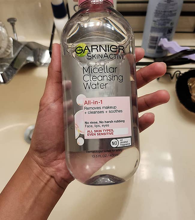 reviewer holding the bottle of micellar water