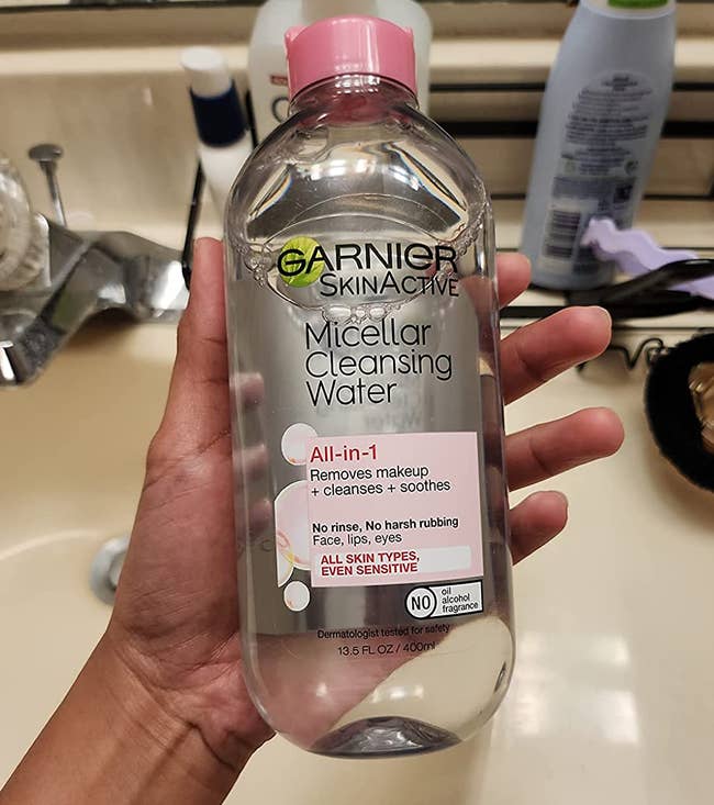 reviewer holding the bottle of micellar water