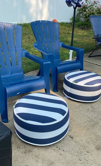 another reviewer photo of two navy and white striped inflatable ottomans in front of two patio chairs