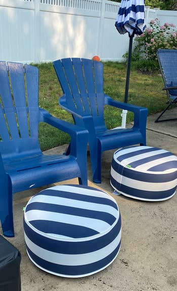 another reviewer photo of two navy and white striped inflatable ottomans in front of two patio chairs