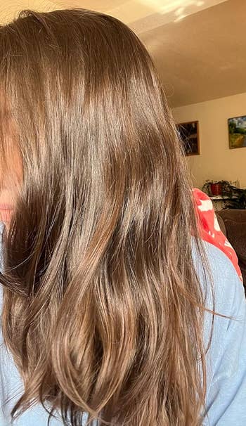 Person with long, creaseless  hairsbreadth  partially covering their face, wrong  a cozy room