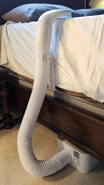 reviewer photo showing the whole bed fan going up the side of a bed without covers on it