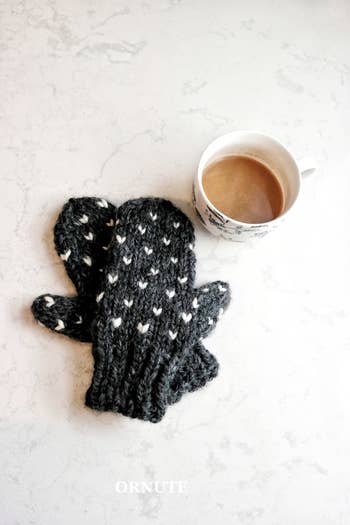 black mittens with little hearts sewn into them