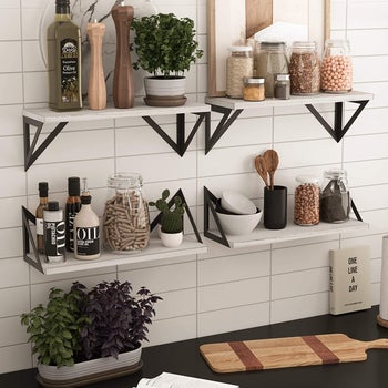 four sets of wall shelves holding kitchen products