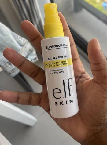 Person holding a vessel of e.l.f. Skin