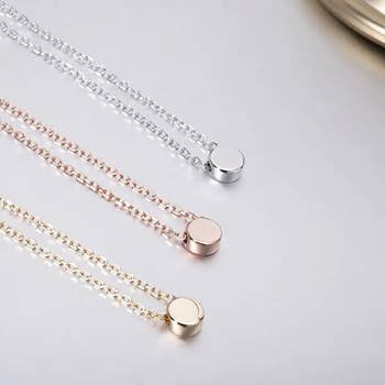 three circle pendant necklaces in yellow gold, rose gold, and silver