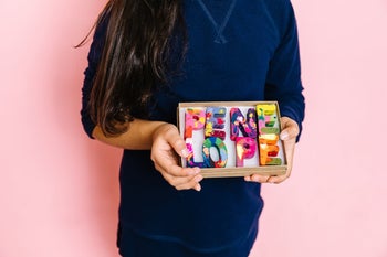 Girl holding a box with the name 