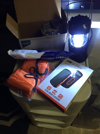 reviewer photo of camping lantern next to camping gear