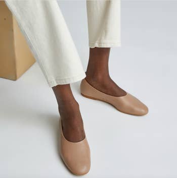 Model wearing the flats in a khaki shade 