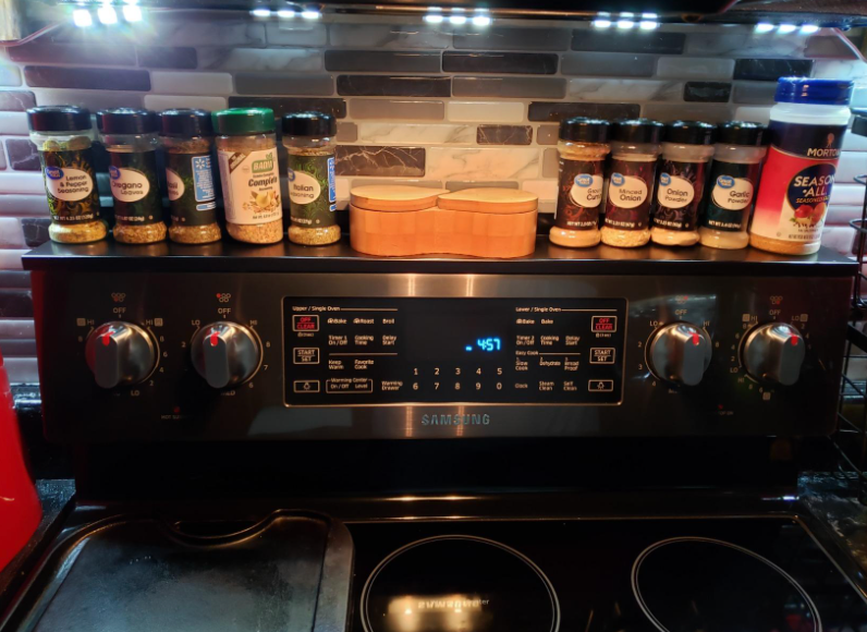 reviewer's stove with various spices lined up on the shelf