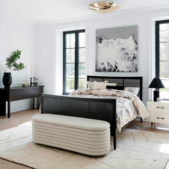 pleated white storage bench at foot of bed