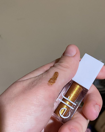 reviewer holding e.l.f. liquid glitter shadow