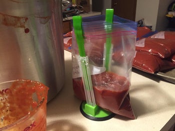 Reviewer photo of a bag of sauce being held up by the stands