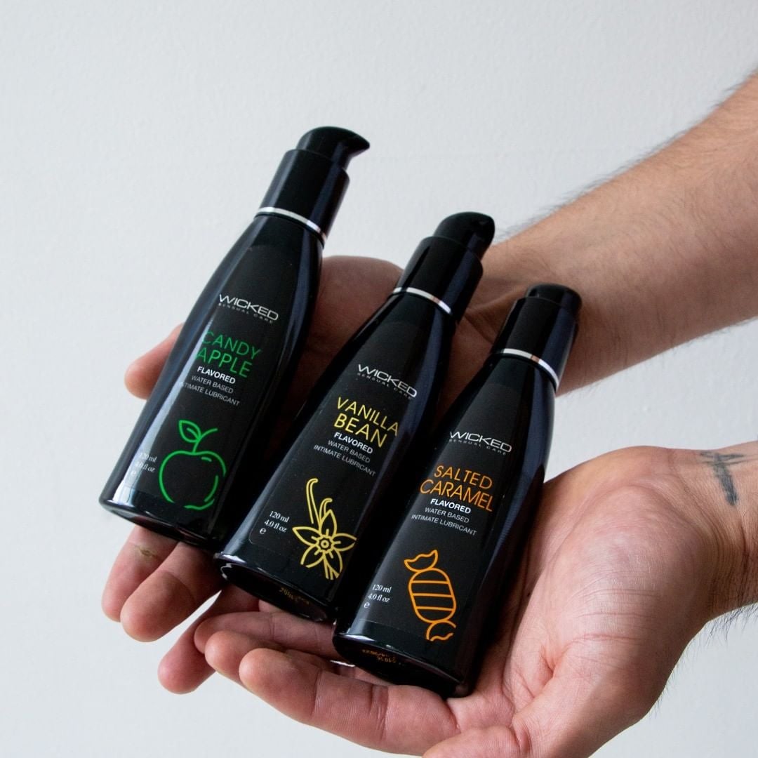 Model holding three bottles of flavored lubricant