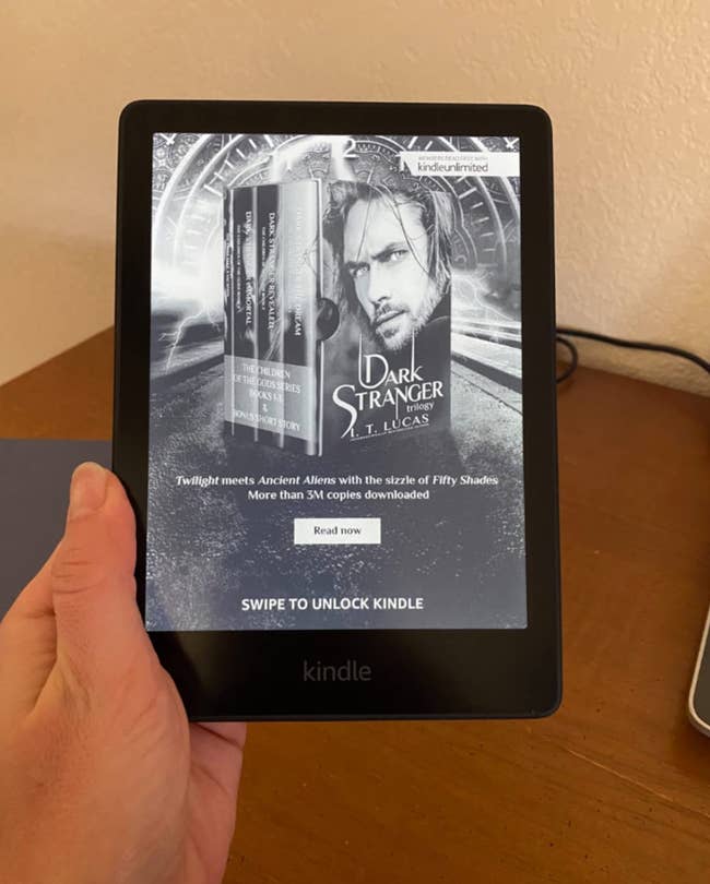 reviewer holding the kindle