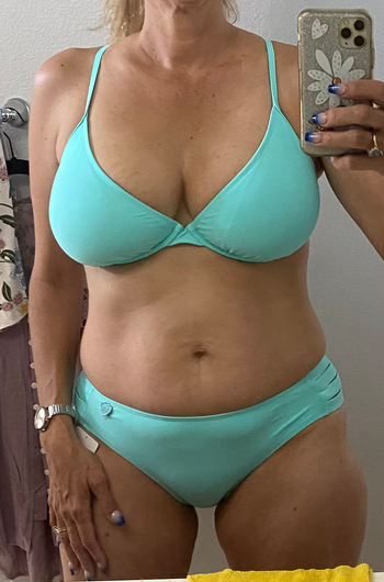 a different reviewer wearing the bathing suit top in light blue