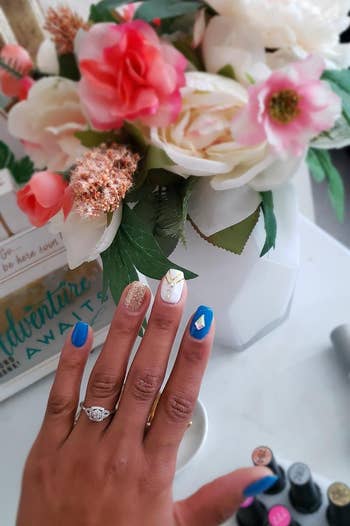 a reviewer's blue and white gel manicure