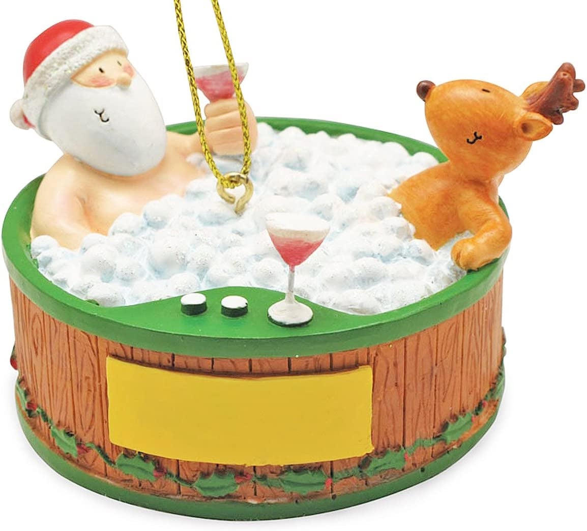 santa and a reindeer drinking cocktails in a hot tub